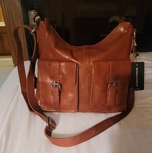 This is a leather brown cross bag from spikes and sparrow. It's a brand new bag